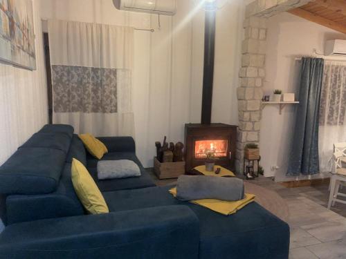 a living room with a blue couch and a fireplace at Luxury house Ivan with 4 bedrooms in Divojevići