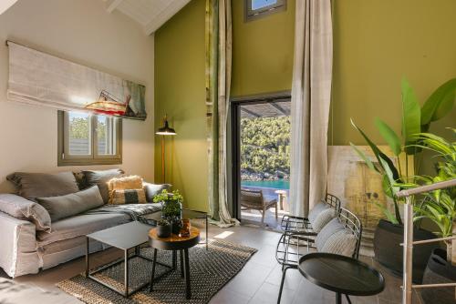 a living room with a couch and a table at Braunis Horio Villas in Asos