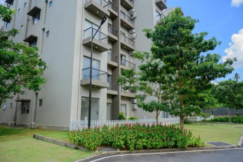 an apartment building with a tree and flowers at Family Friendly 3BR Apartment in Malabe, Colombo in Talahena