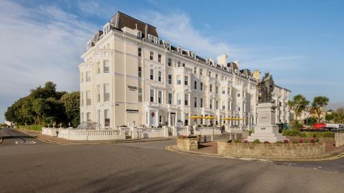 a large white building sitting on the side of a street at voco The Clifton Folkestone by IHG in Folkestone