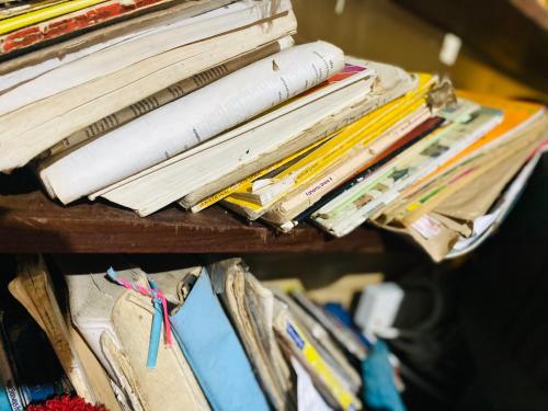 a pile of books and papers on a table at Marcel stays in Mwanza