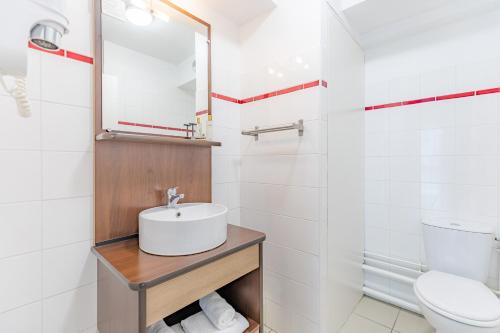 a bathroom with a sink and a toilet at Appart'City Confort Pau Centre in Pau