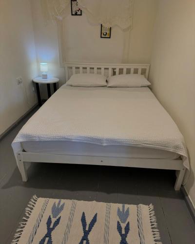 a bed in a small room with a white mattress at View Racha in Ambrolauri
