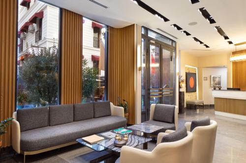 a living room with a couch and chairs and a table at Me by Mula in Istanbul