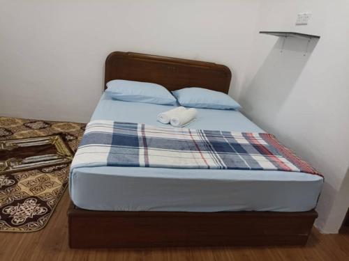 a bed with a white object sitting on top of it at D'Tanjung Roomstay, Pekan Pahang in Pekan
