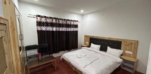 a bedroom with a large bed and a window at Hunder Tamarix Resort in Hundar