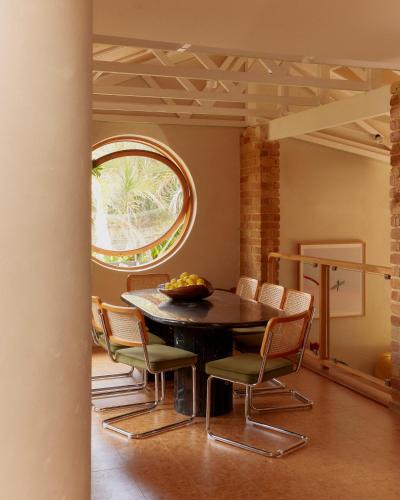 a dining room with a table and chairs at The Sunseeker, Byron Bay in Byron Bay