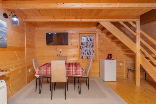 a dining room with a table and chairs at Green Top with jacuzzi in Žabljak