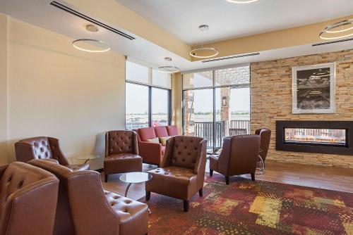 a waiting room with couches and chairs and a fireplace at The Hotel at Sunland Park Casino El Paso, an Ascend Collection Hotel in El Paso