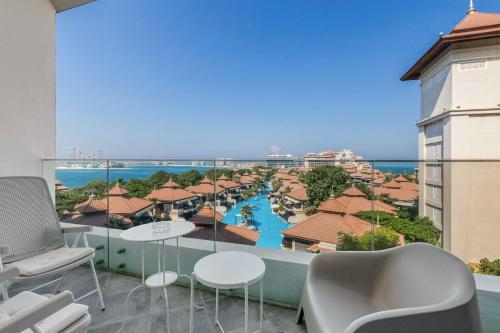 a balcony with a view of a resort at GlobalStay Azizi Mina Beachfront Apartments Palm Jumeirah in Dubai
