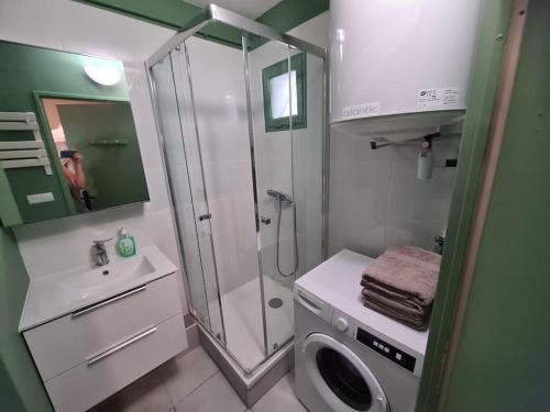 une salle de bain avec douche et machine à laver dans l'établissement Appartement Evasion Ensoleillée - Parking Jardin, à La Ciotat
