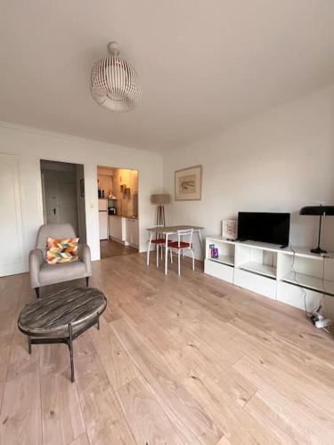 un salon avec une chaise et une télévision dans l'établissement Confort porte de la Croisette, à Cannes