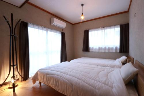 Postel nebo postele na pokoji v ubytování 奥大和ビール TAP to BED
