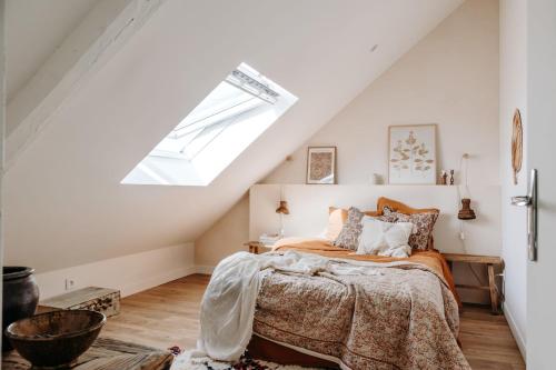 une chambre avec un lit et une lucarne dans l'établissement Bohème Chic - Standing - Calme, à Rouen