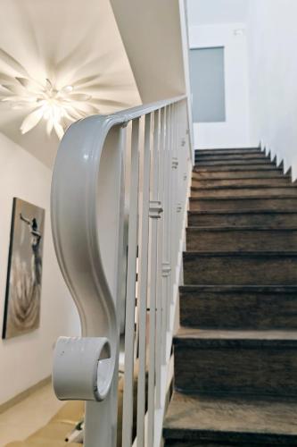 a stairway with a white railing and a stair case at The Sunset in Marsaskala