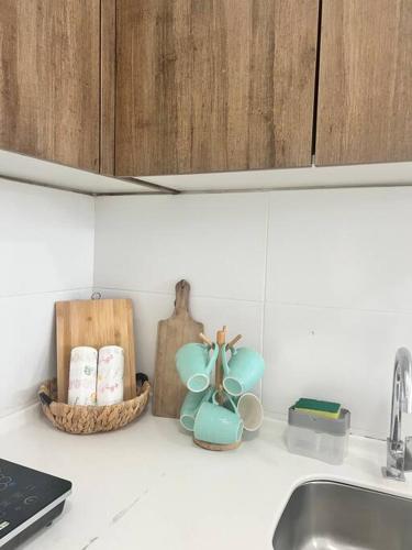 a kitchen counter with a sink and some items on it at Lily Avillion-Tanah Rata in Tanah Rata