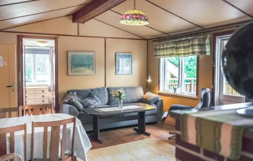 a living room with a couch and a table at 1 Bedroom Amazing Apartment In Vetlanda in Vetlanda