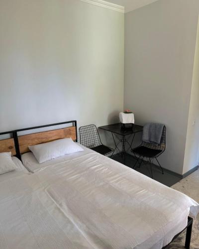 a bedroom with a bed and a table with chairs at View Racha in Ambrolauri
