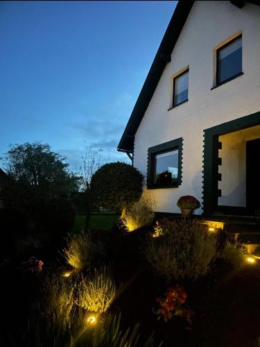 a house with lights in front of a yard at Landhaus "Marcomagus" in Kall