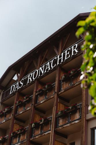 a sign on the side of a building with flower boxes at DAS RONACHER Thermal Spa Hotel in Bad Kleinkirchheim