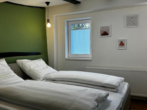two beds in a room with a window at Casa BACCO in Rotenburg an der Fulda