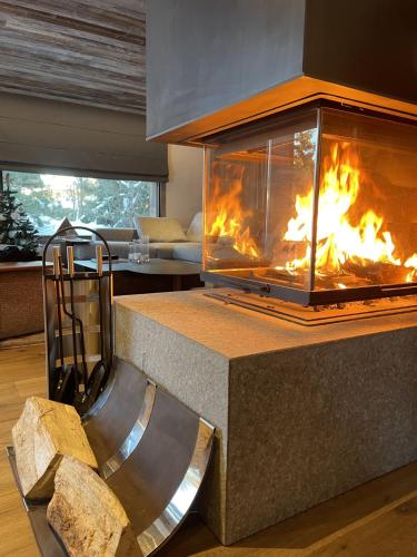 a fireplace in a living room with flames in it at Chalet Esquinade 4 bedrooms appartment Megève in Megève