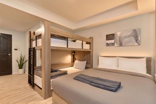 a bedroom with a bunk bed with white pillows at Thapae60 Mini Hotel in Chiang Mai
