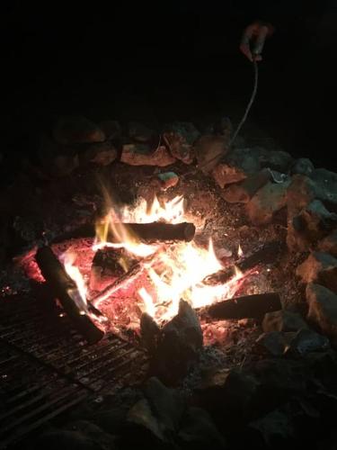 a grill with a bunch of fire in it at Historical Country Retreat with Modern Amenities in Gravesend