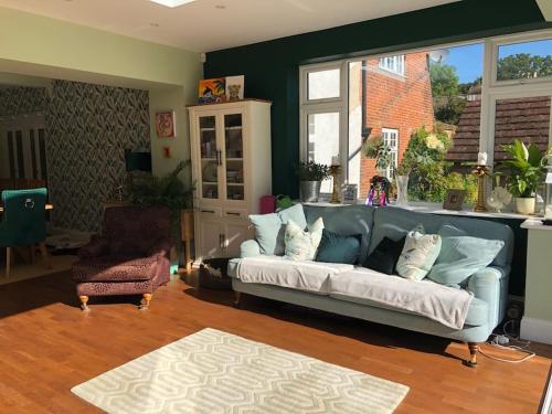 a living room with a couch and a chair at Historical Country Retreat with Modern Amenities in Gravesend