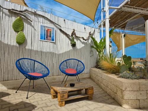 two blue chairs and a table on a patio at Villaggio Porticello Mare in Vieste