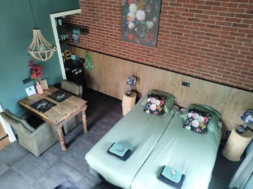 an overhead view of a room with a bed and a table at B & B Chawe in Enschede