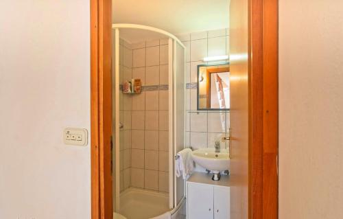 a bathroom with a sink and a shower at Ferienhaus ADRIENNE 100m vom Strand in Martinšćica