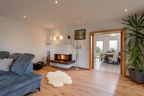 a living room with a couch and a fireplace at Villa Werlberger in Thiersee
