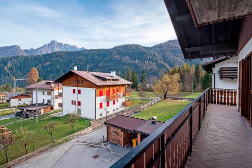 a balcony of a house with a view of a mountain at Appartamenti Minotto Falcade in Falcade