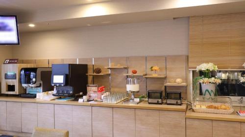 a food counter in a restaurant with a unintention at Dormy Inn Gifu Ekimae in Gifu