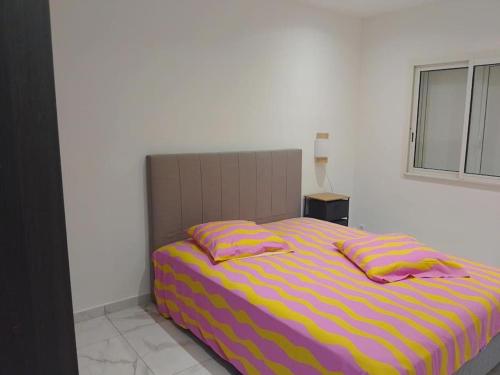 a bed with two pillows on it in a bedroom at Villa de l'Océan in Saint-Pierre