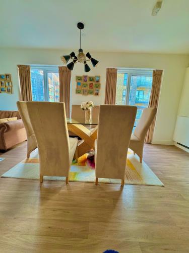 a dining room with a table and chairs at The Mirrored House in Kent