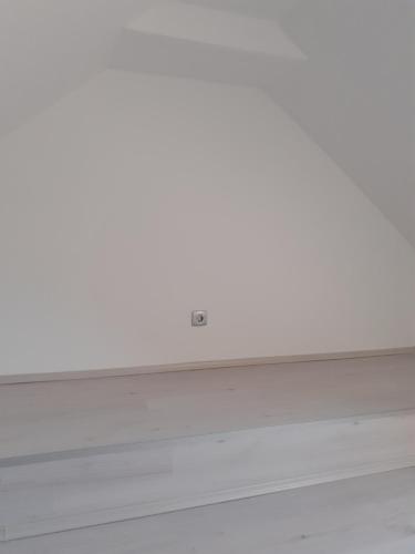 an empty room with a white wall and a window at Varkor Villa at the castle in Kőszeg