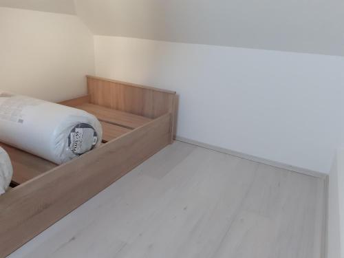 a room with a bed and a white wall at Varkor Villa at the castle in Kőszeg
