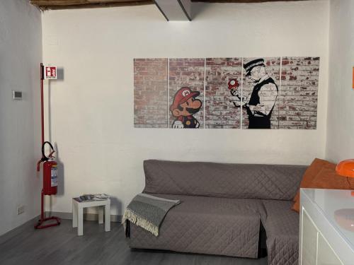 a bedroom with a bed and a brick wall at Il Pentolo in Sansepolcro