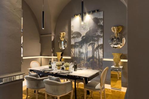 a dining room with a table and chairs at Maison boutique At Pietro in San Pietro in Lama