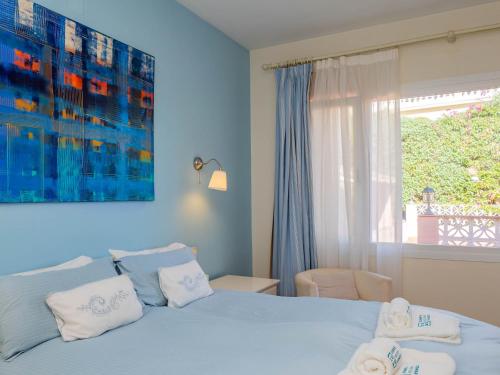 a blue bedroom with a bed and a window at Cubo's Villa Las Capuchinas in Torremolinos