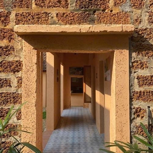 an empty hallway of a building with a brick wall at Moncada Villa - Ba vì- 10km to Đường Lâm in Yên Cư