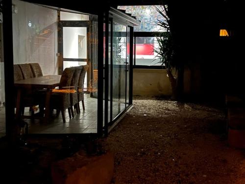 a room with a table and chairs and a window at La Lone 1870 in La Roche-de-Glun