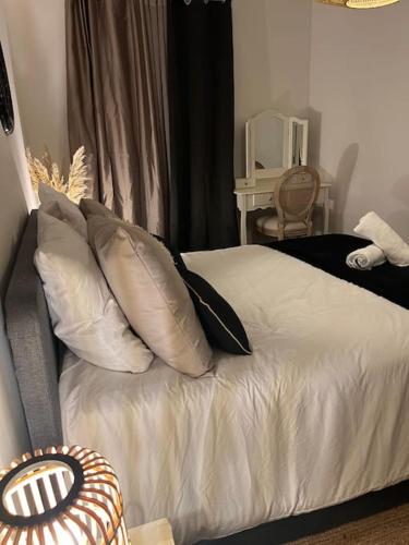 a bed with pillows on it in a bedroom at La Lone 1870 in La Roche-de-Glun
