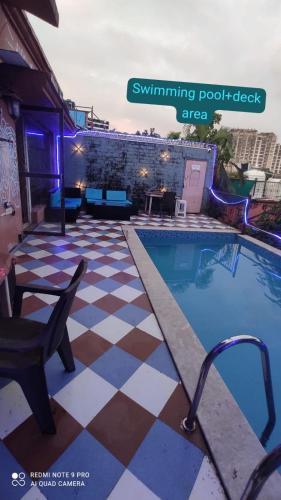 a pool with a checkered floor next to a building at SHAH SOCIAL PARTY VILLA In Royal Palms Mumbai in Mumbai