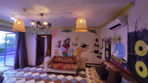 a living room with a painting on the wall at SHAH SOCIAL PARTY VILLA In Royal Palms Mumbai in Mumbai