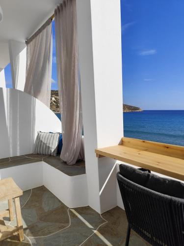 a room with a window with a view of the ocean at Ammos Sifnos Village in Platis Yialos Sifnos