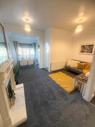 a living room with a couch and a fireplace at Relaxing Getaway in South Shields! in Jarrow
