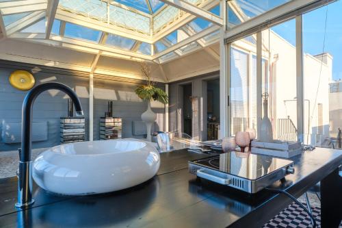 a bathroom with a large tub on a counter at Maison Boutique At Daniela in San Pietro in Lama